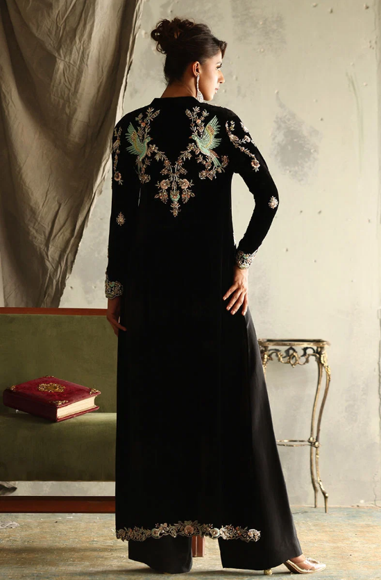 Back view of black velvet suit showing bird and floral embroidery across shoulders