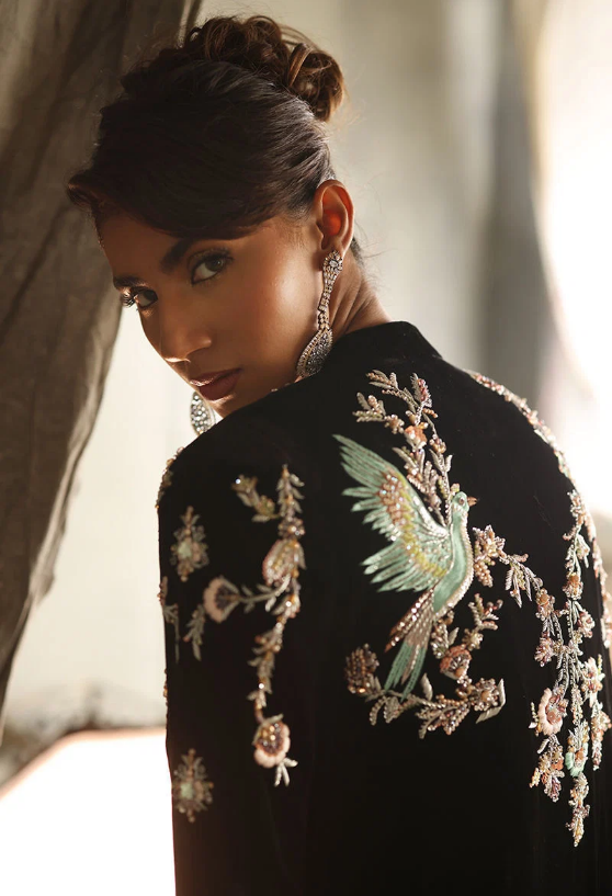 Back view of black velvet suit showing bird and floral embroidery across shoulders