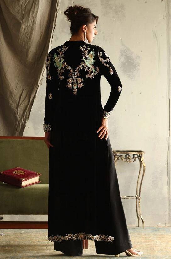 Back view of black velvet suit showing bird and floral embroidery across shoulders