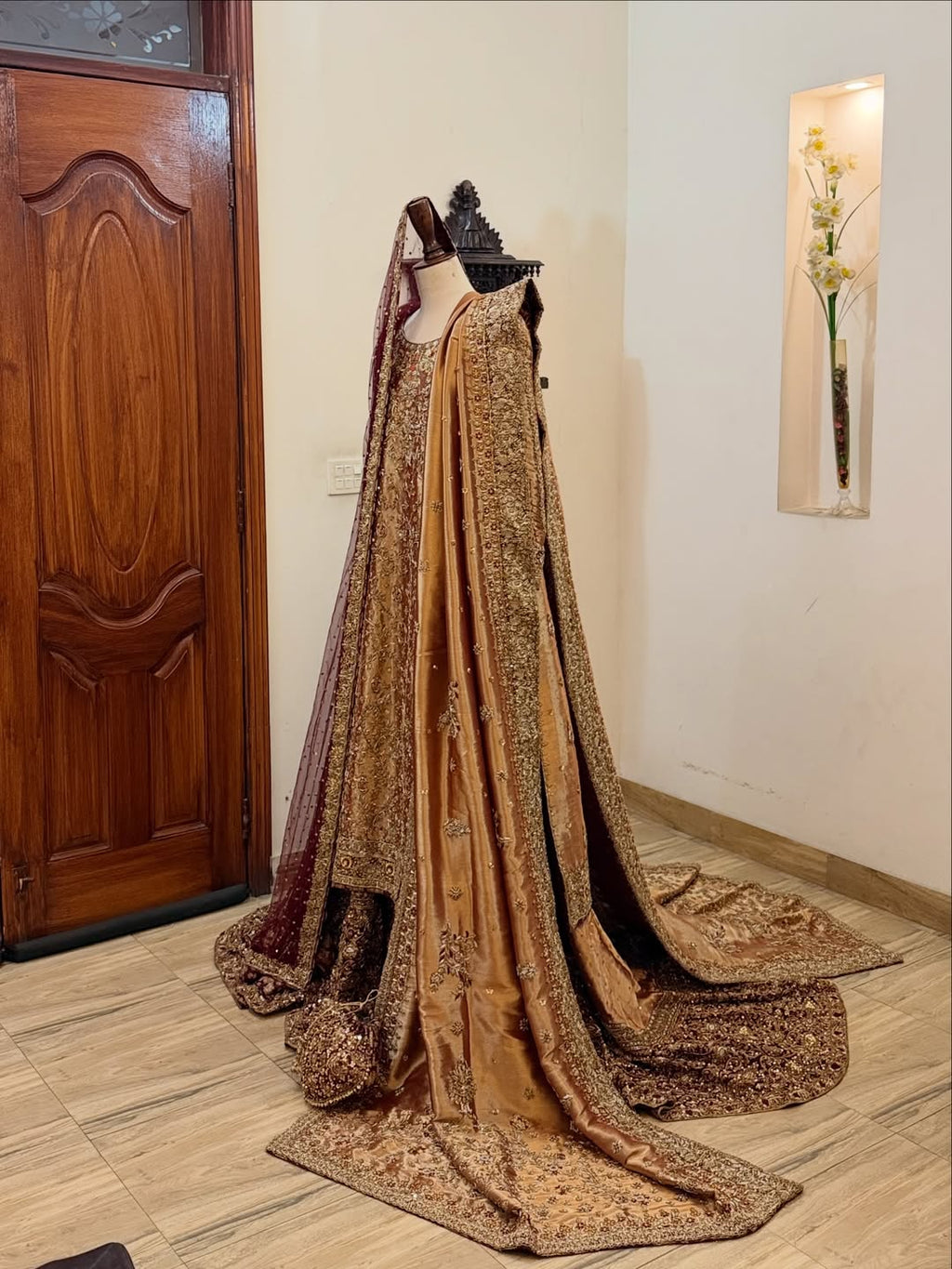Front view of antique gold bridal dress with dense embroidery and maroon dupatta on mannequin - Èlaan Studio bridal couture