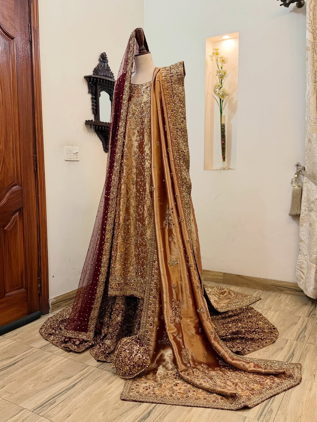 Front view of antique gold bridal dress with dense embroidery and maroon dupatta on mannequin - Èlaan Studio bridal couture