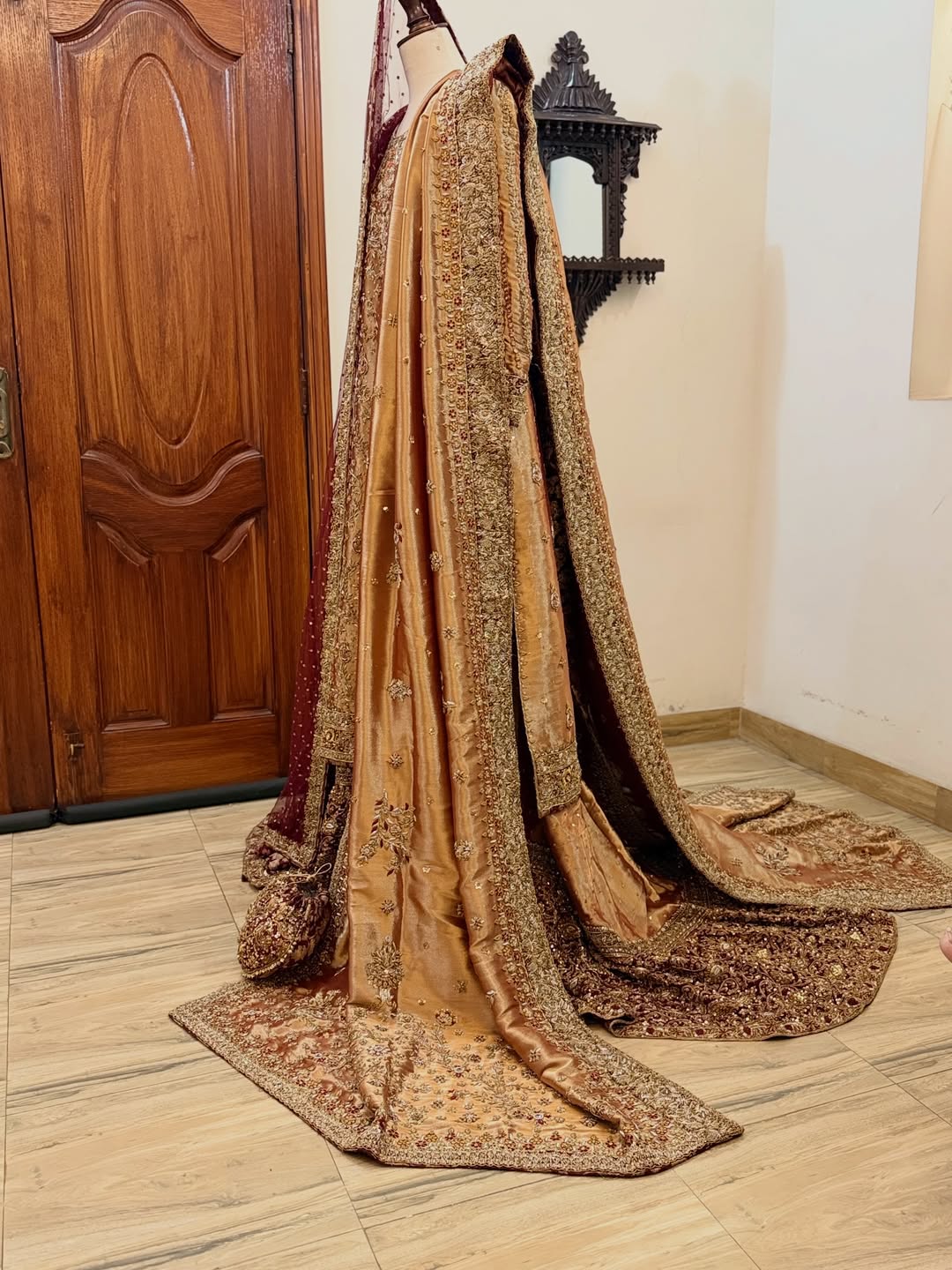Front view of antique gold bridal dress with dense embroidery and maroon dupatta on mannequin - Èlaan Studio bridal couture