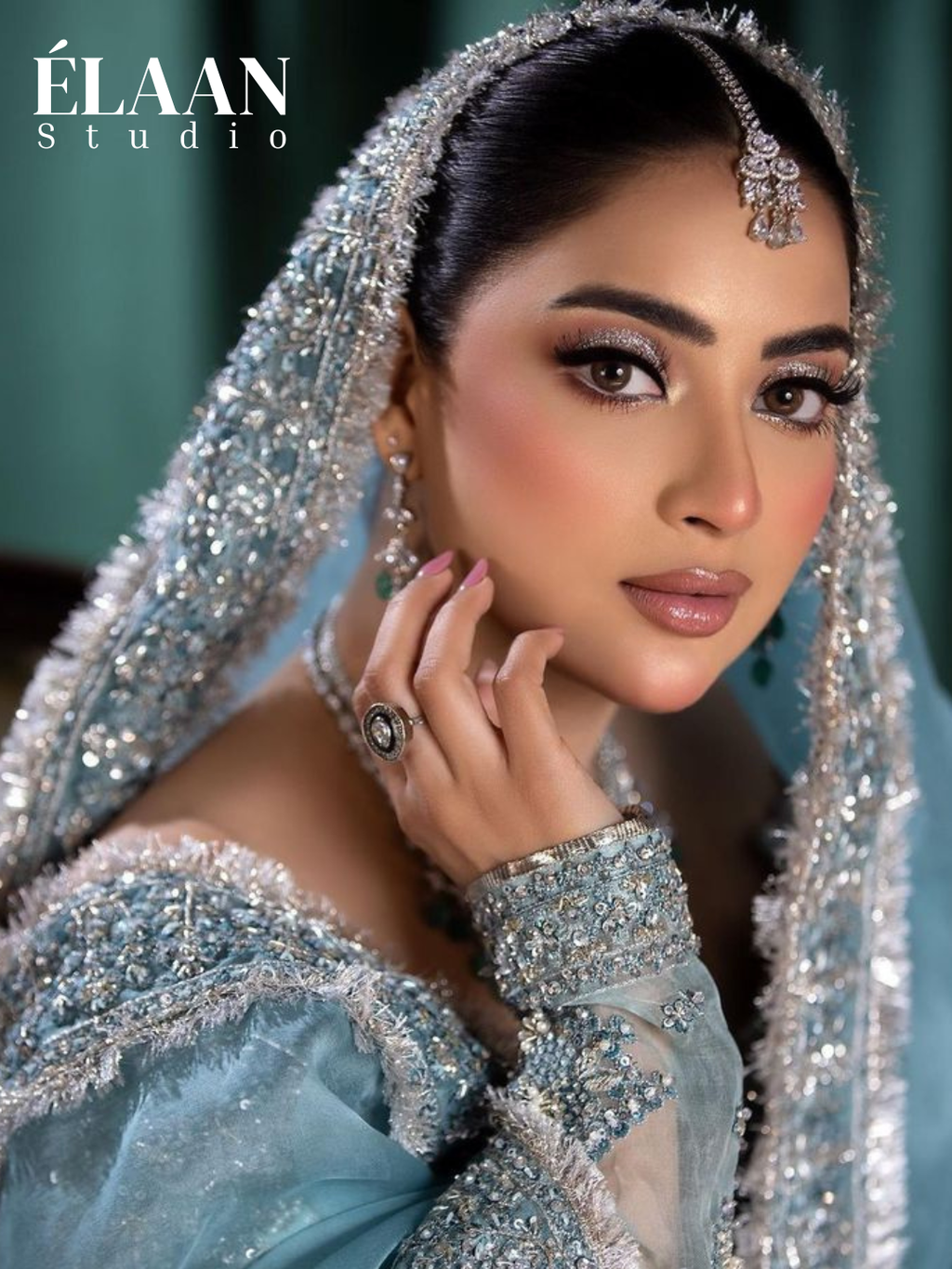 Model wearing powder blue embellished anarkali gown with silver embroidered dupatta and tasseled potli bag - Èlaan Studio bridal wear