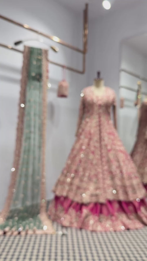 Luxury Pakistani bridal lehenga in blush pink with intricate hand embroidery, paired with a mint green embellished dupatta by Elaan Studio